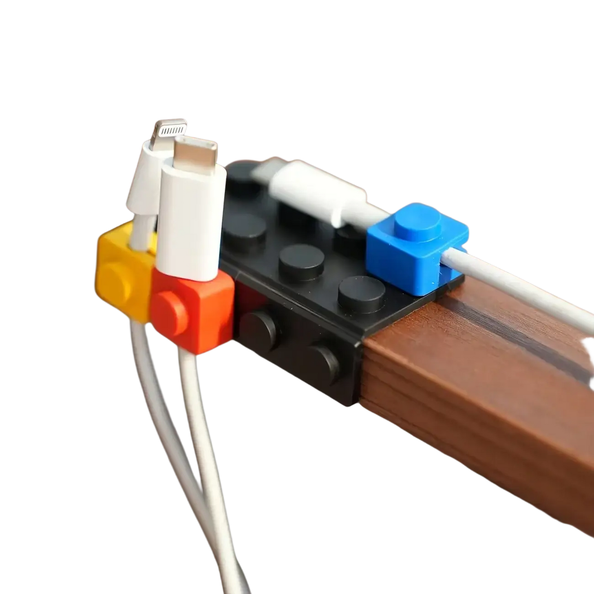 Modular brick cable organizer 2 sets with black and colorful lego-style bricks holding white charging cables