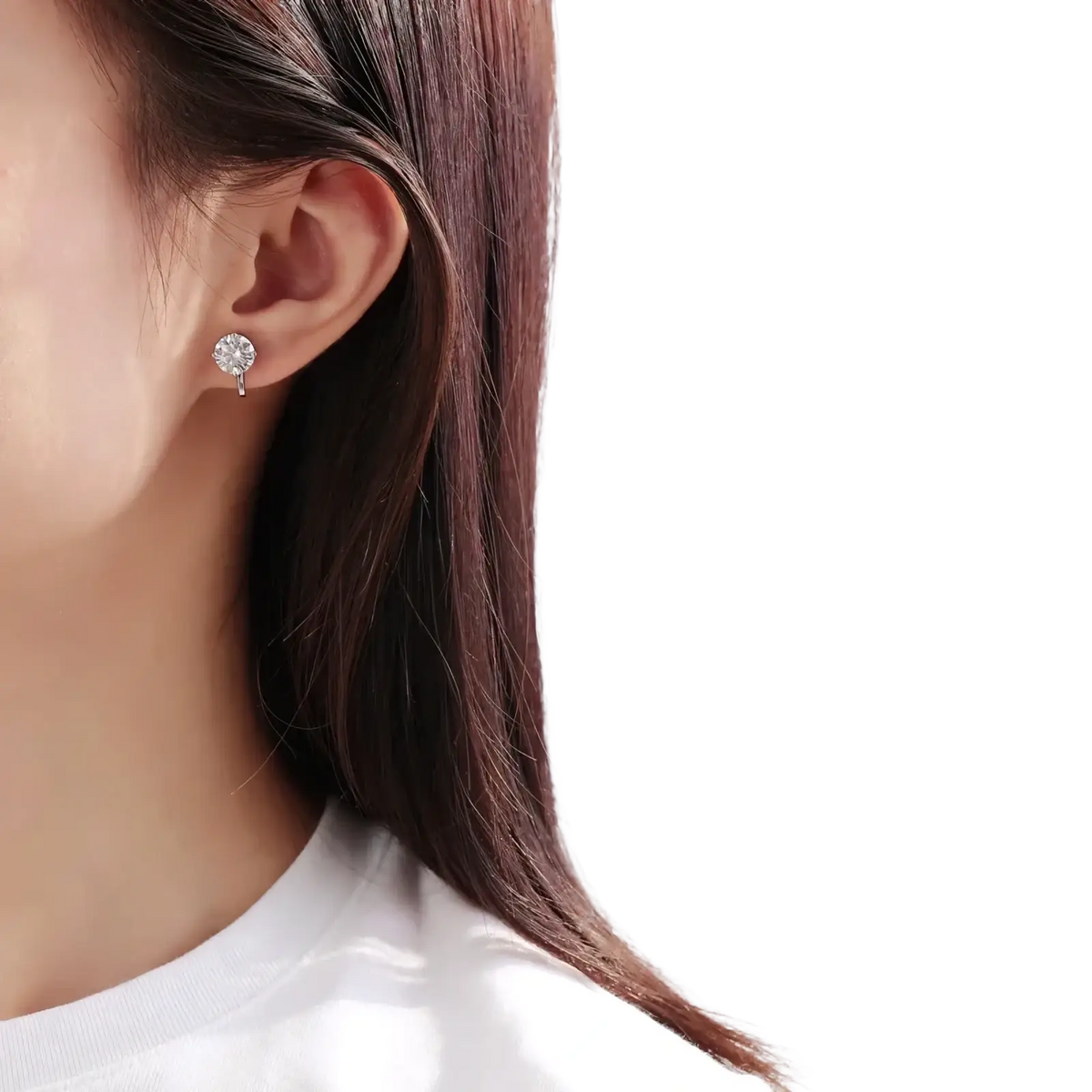 A delicate silver 925 sterling moissanite clip on earring with a round sparkling diamond centerpiece