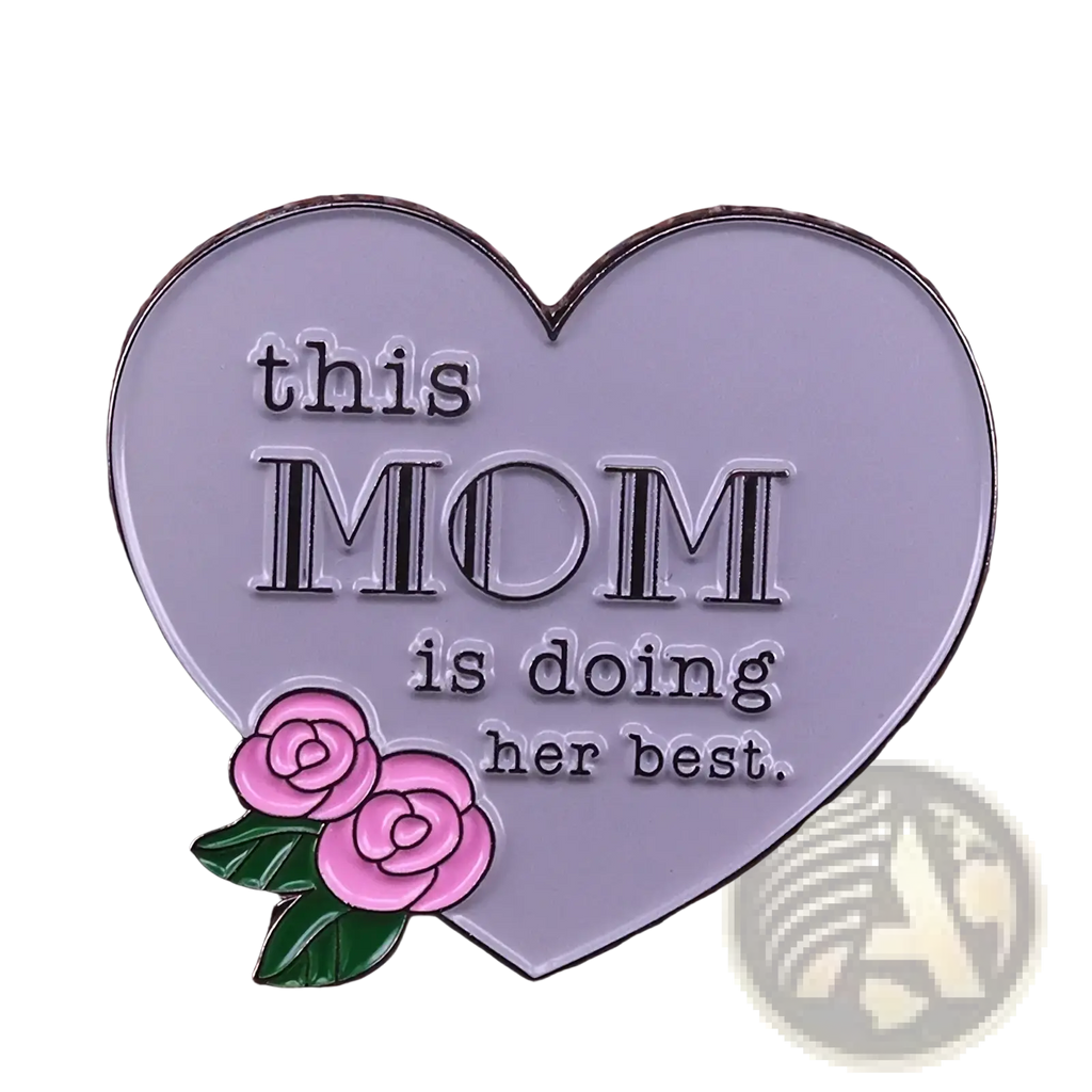 A silver heart-shaped enamel pin with pink roses and the inscription this mom is doing her best for mothers