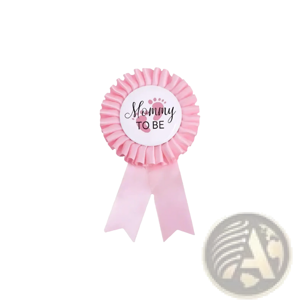 Pink mommy to be ribbon badge with ruffled edges and black cursive text for mom to be sash and badge gender reveal kit