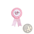 Pink mommy to be ribbon badge with ruffled edges and black cursive text for mom to be sash and badge gender reveal kit
