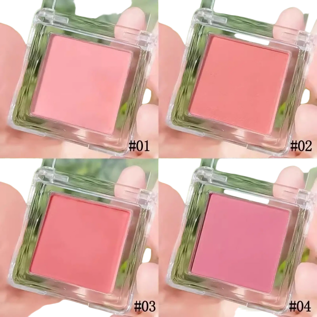 Monochrome powder blush compact with brush featuring clear square case and four shades of pink and coral hues