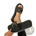Black monogram platform slide sandals with gold-tone buckle and subtle patterned fabric for stylish wear