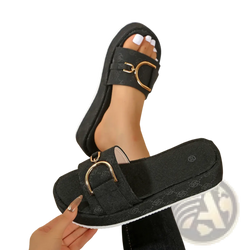 Black monogram platform slide sandals with gold-tone buckle and subtle patterned fabric for stylish wear