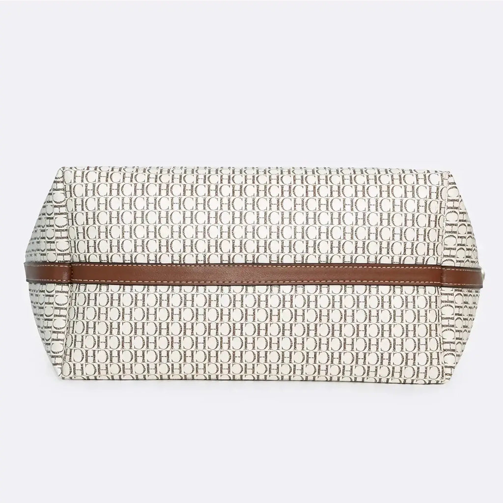 Beige and black monogram tote bag with large capacity and brown leather strap shown as a clutch accessory