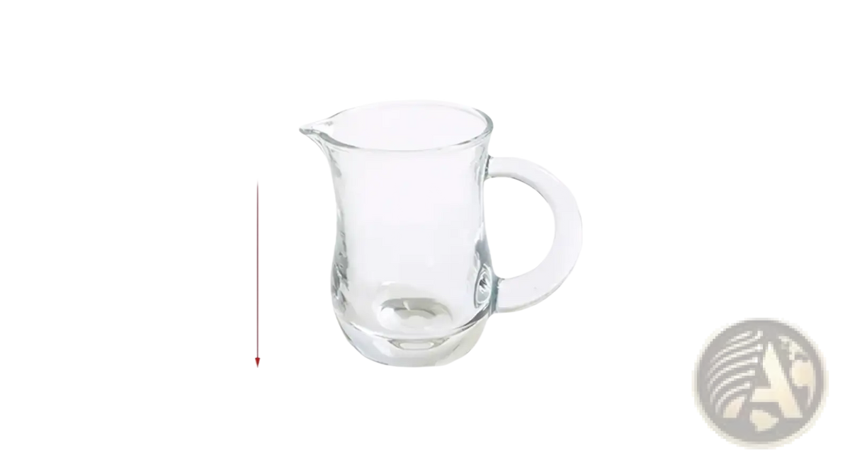 Clear glass pitcher with curved handle and spout measuring 6 cm by 8.4 cm in montessori kitchen tool set for kids