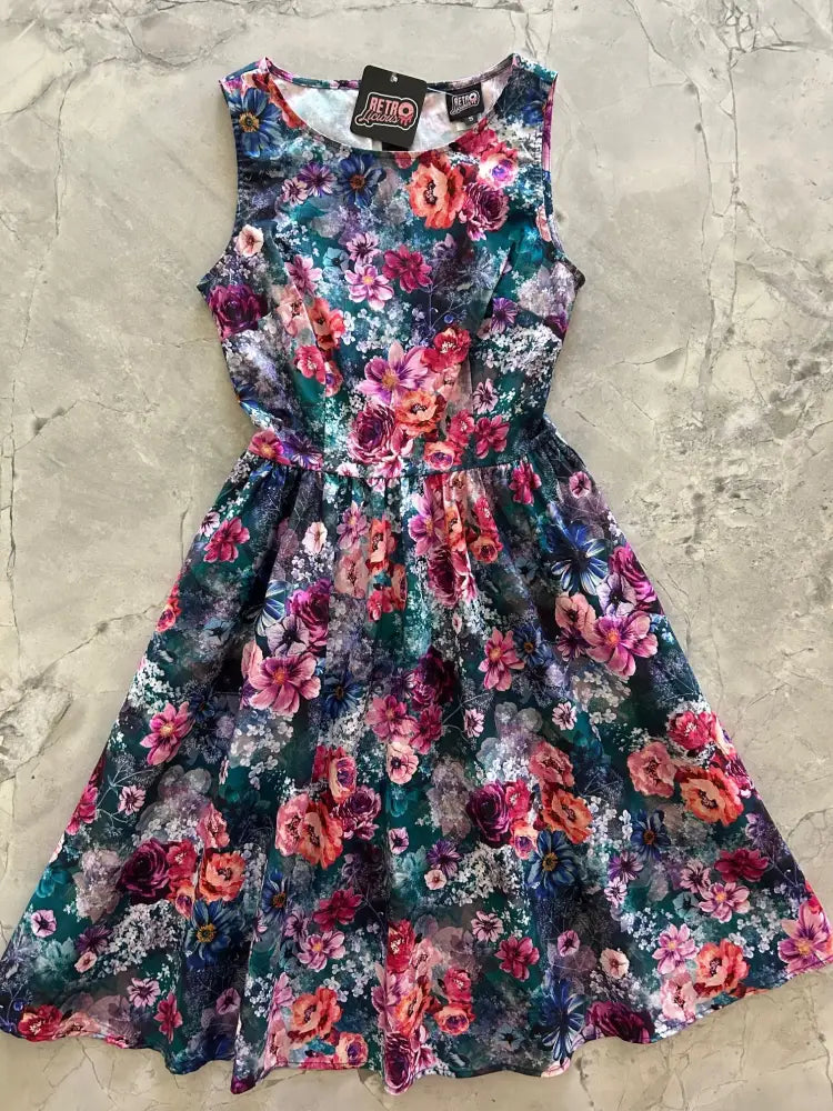 Moody floral 1950s vintage cotton midi dress with pockets featuring sleeveless fitted bodice and vibrant floral print