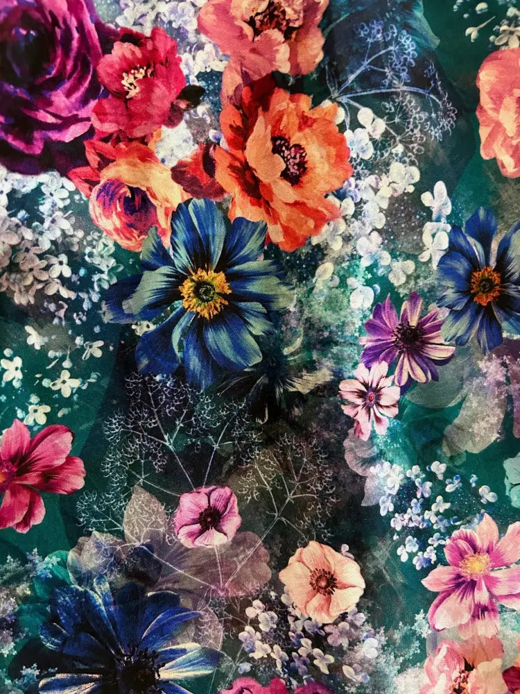Moody floral 1950s vintage cotton midi dress with pockets featuring vibrant red orange and blue blossoms on teal fabric