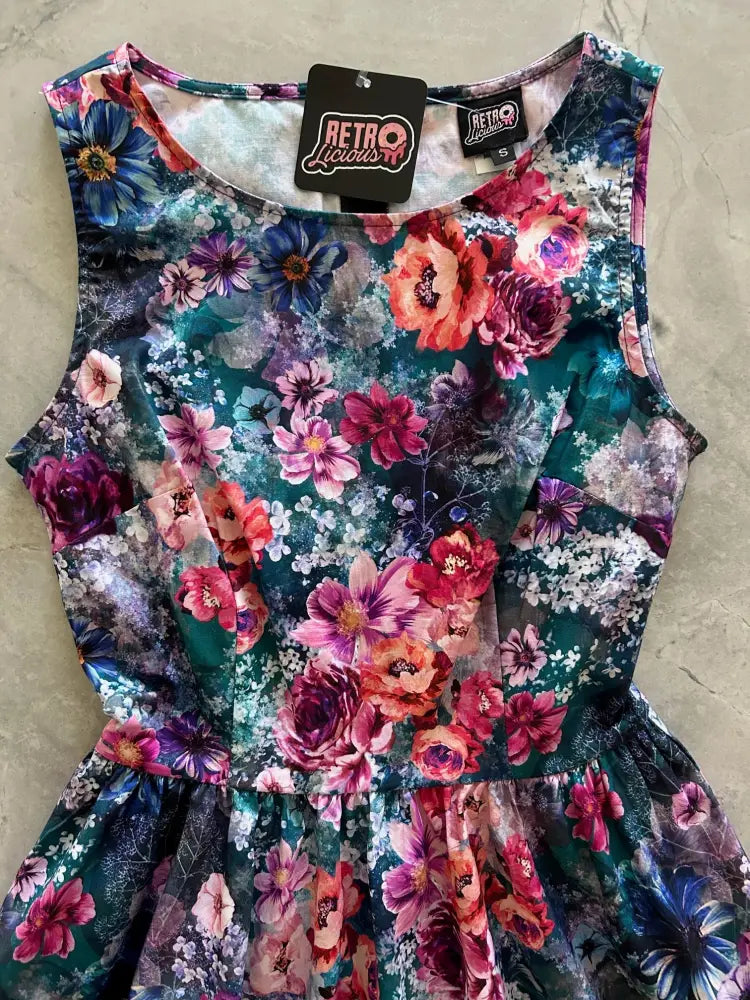 Moody floral 1950s vintage cotton midi dress with pockets and ruffled hemline in teal pink and purple floral print
