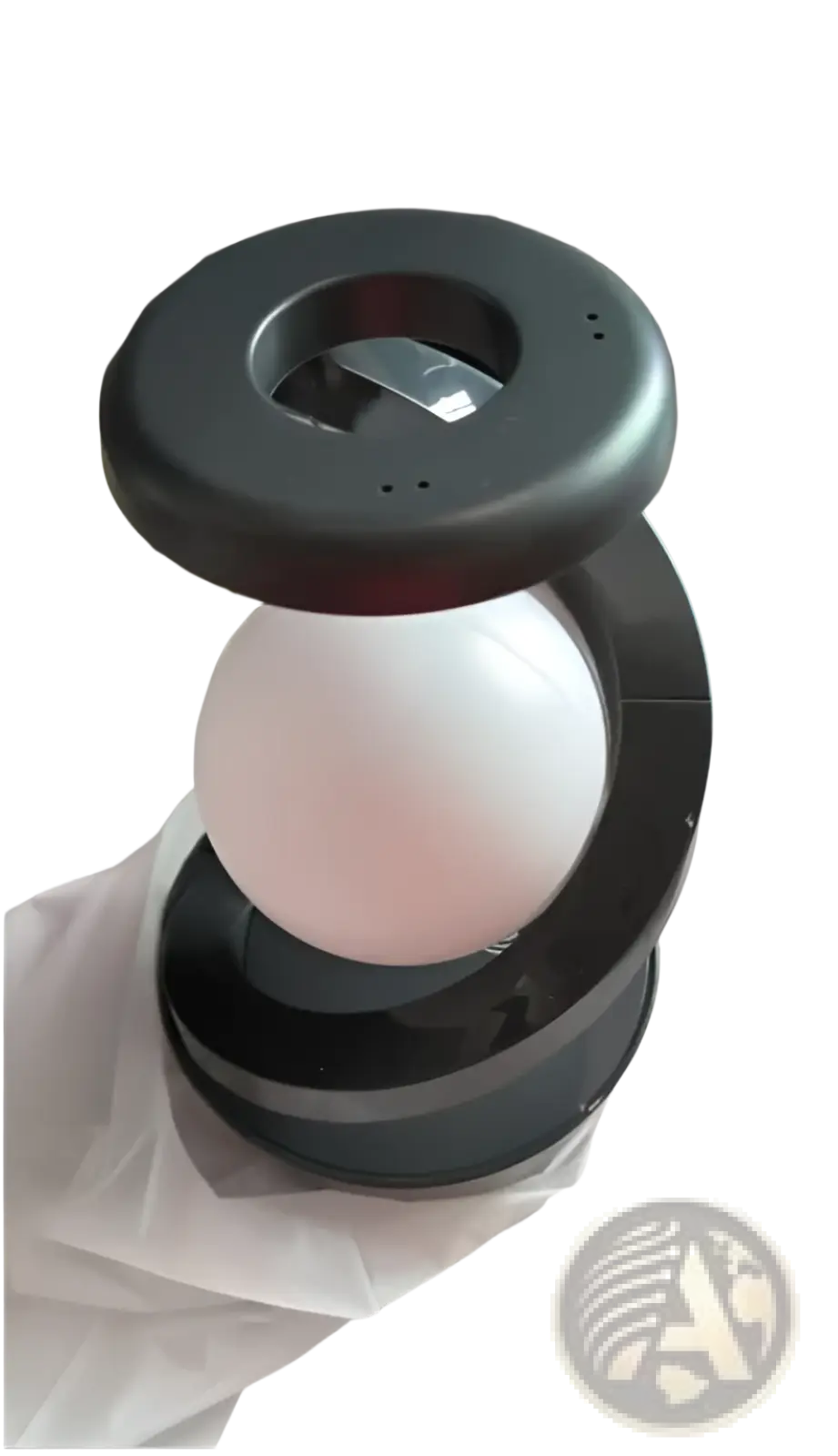 Black magnetic levitation moon desk lamp with glowing white spherical bulb wireless charging and sensor control
