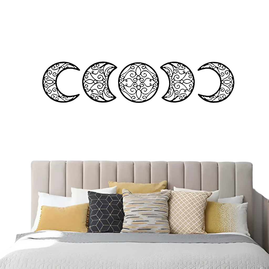 Black metal wall art featuring five intricately designed moon phases with swirling patterns for home decor