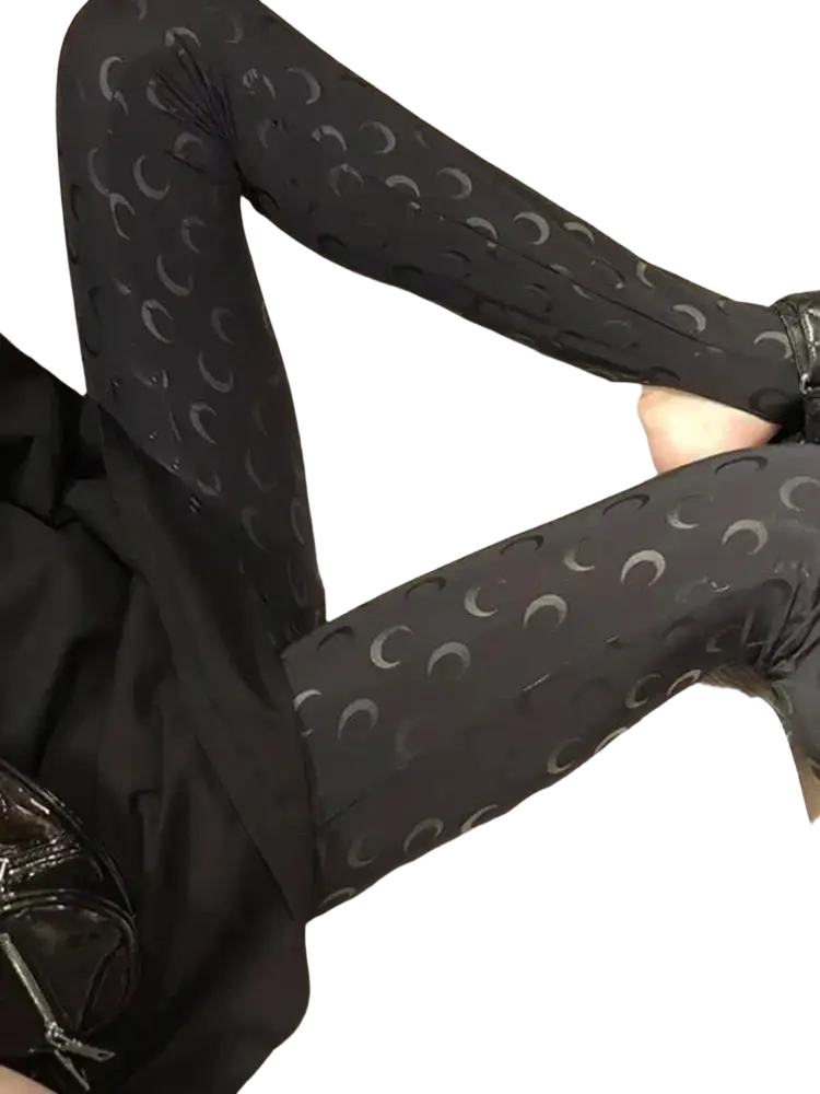 Black high waist leggings with a repeating pattern of silver crescent moons on the front side