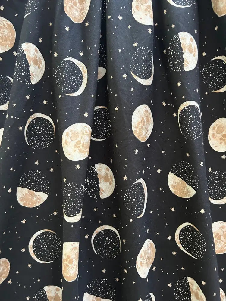 Black cotton curtain with a vintage moon phase pattern in beige and white featuring small star accents