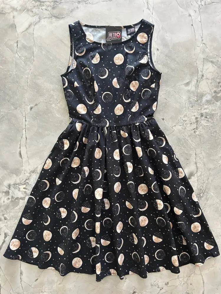Black sleeveless cotton midi dress with flared skirt featuring gold and white moon phase pattern vintage celestial design