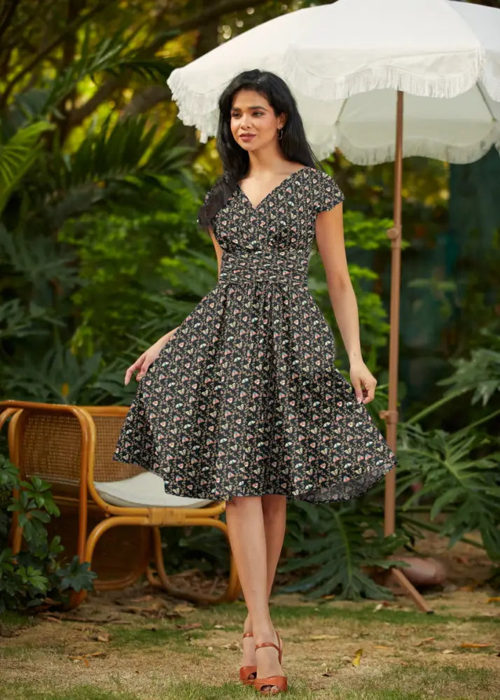Black floral print a-line cotton wrap dress with short sleeves v-neckline and pockets by Moth Greta