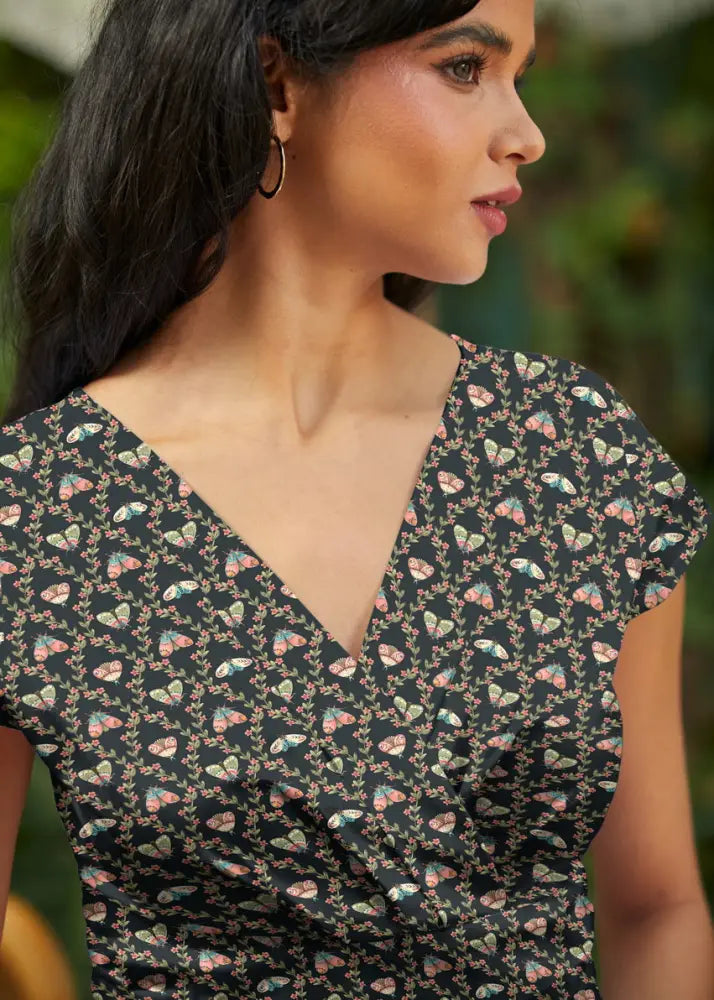 Moth greta black floral cotton wrap dress with pockets featuring a delicate pink and green butterfly pattern