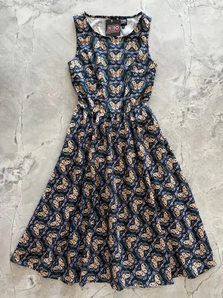 A vintage moth print navy cotton midi swing dress with sleeveless fitted bodice and flared skirt featuring beige and purple butterflies