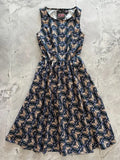 A vintage moth print navy cotton midi swing dress with sleeveless fitted bodice and flared skirt featuring beige and purple butterflies