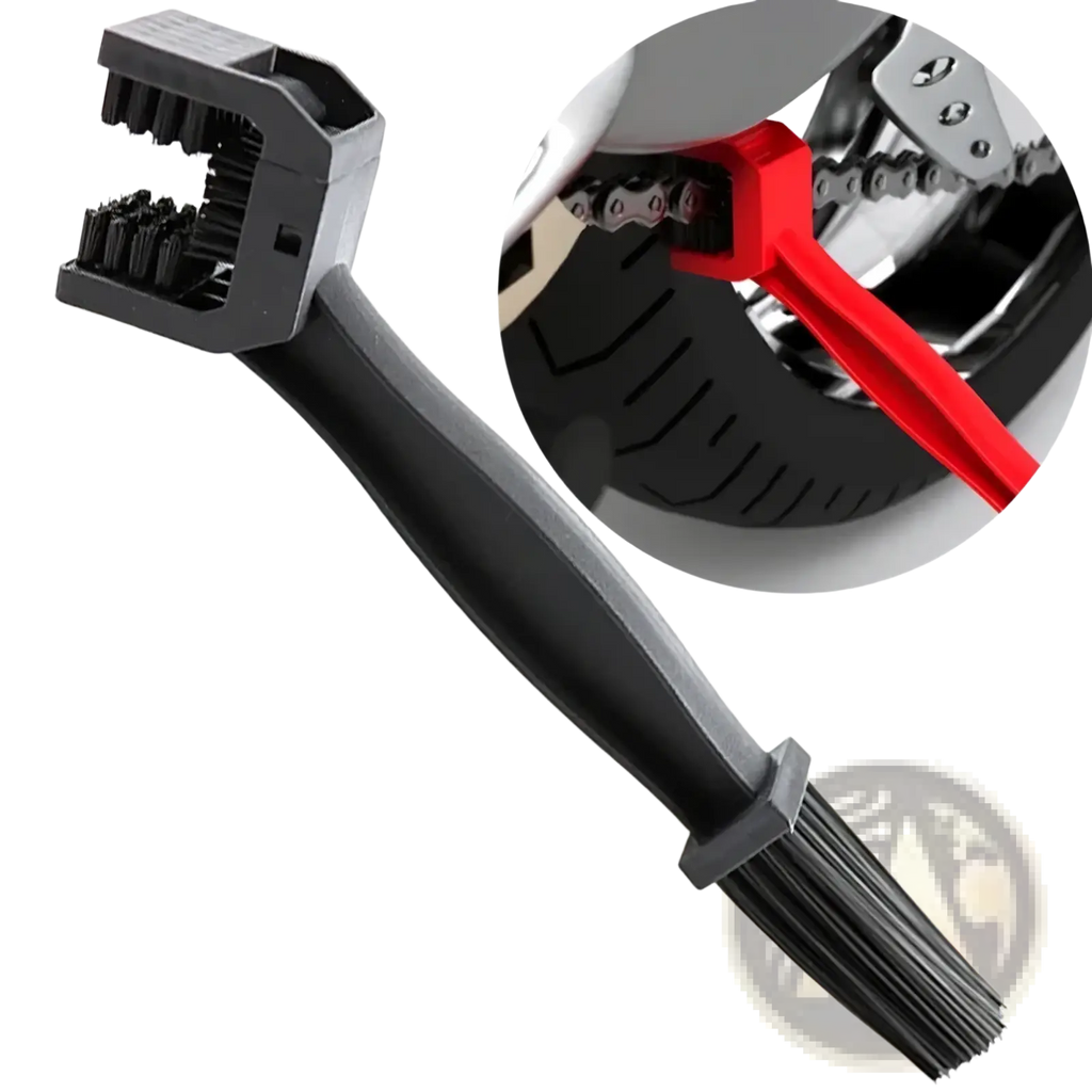 Black plastic motorcycle chain brush cleaner with dual-sided bristle heads and red handle shown cleaning a bike chain
