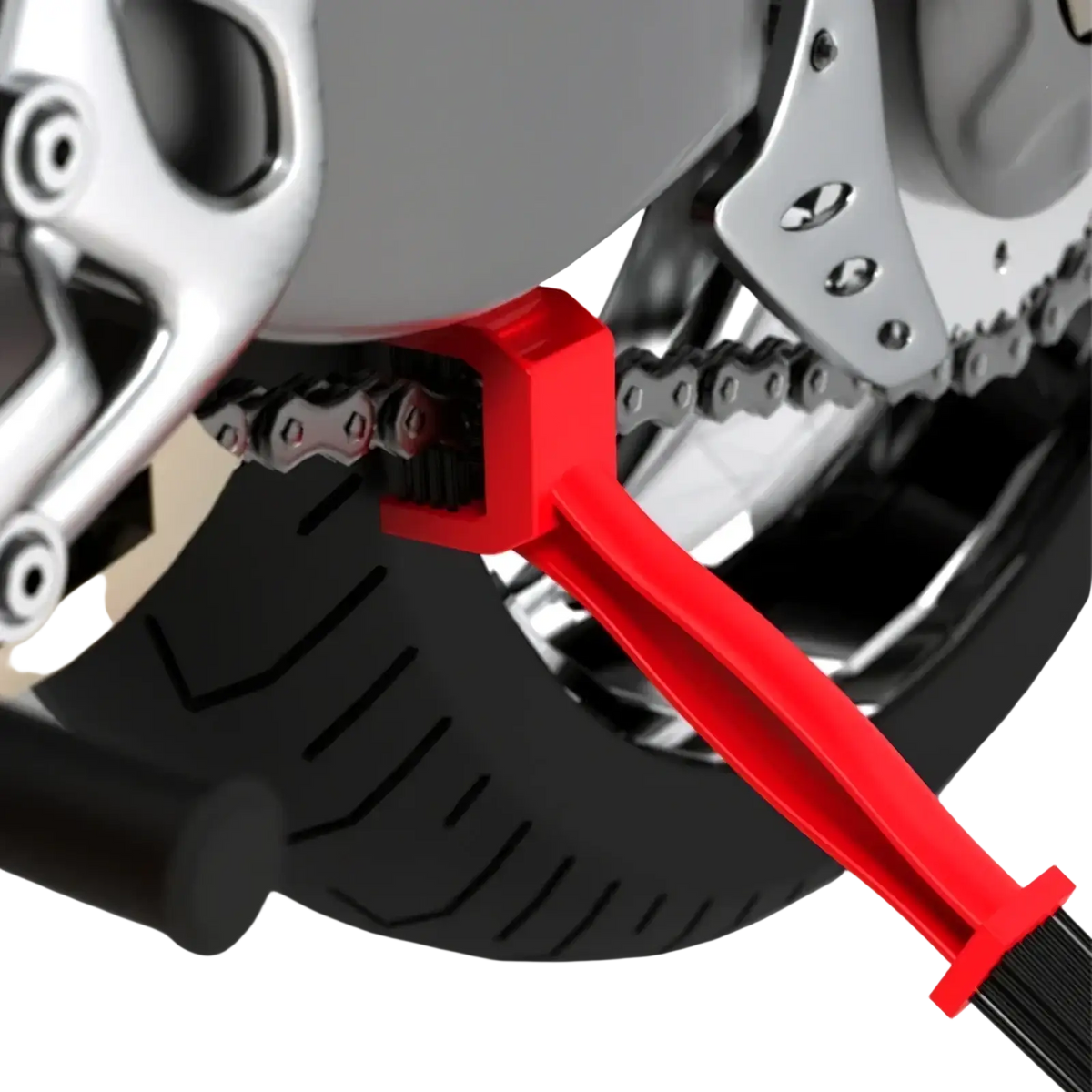 Red plastic motorcycle chain brush cleaner tool with black bristles for effective chain maintenance and cleaning