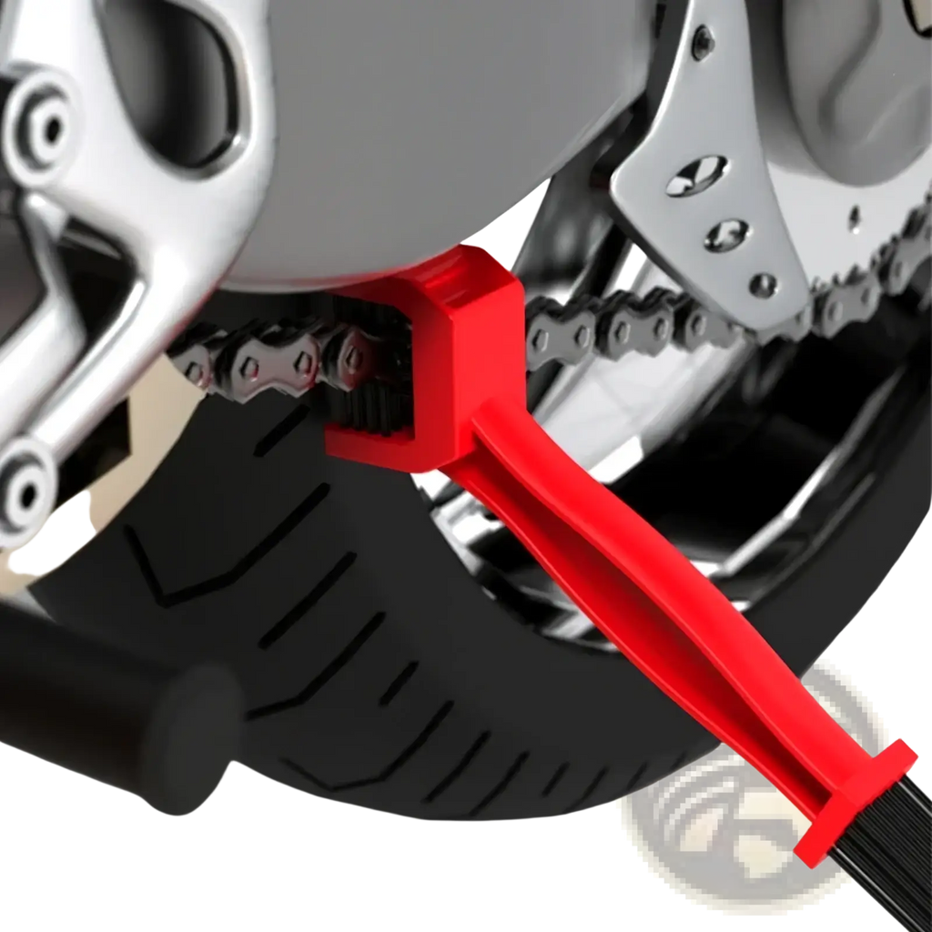 Red plastic motorcycle chain brush cleaner tool with black bristles for effective chain maintenance and cleaning