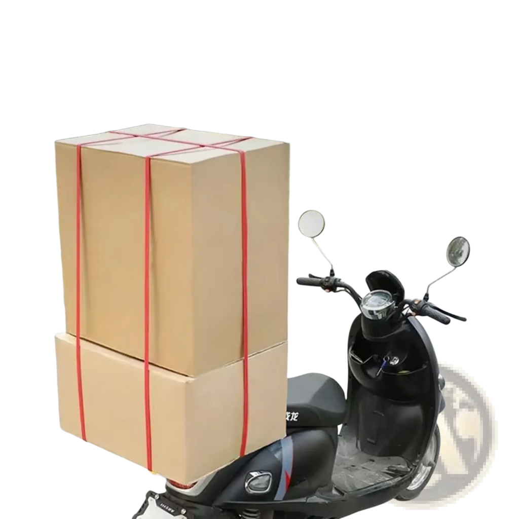 Red elastic motorcycle luggage straps securing two stacked brown cardboard boxes for auto roof rack use
