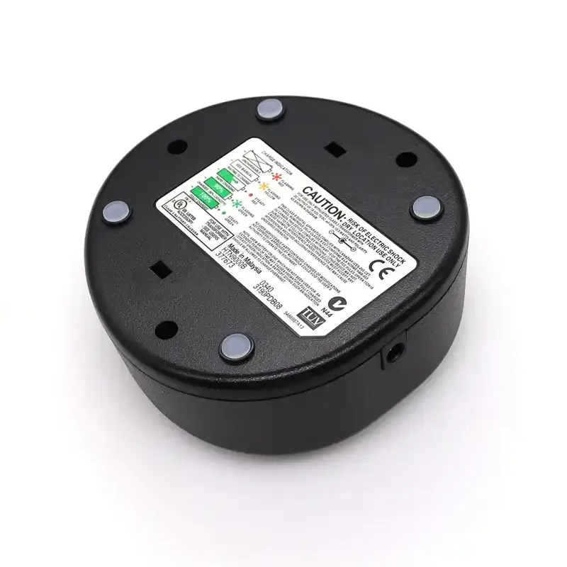 Black circular back panel of motorola walkie talkie desktop charger with safety label and silver screws for gp328 ht750