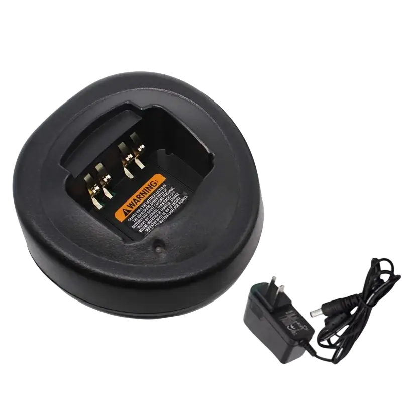 Black circular Motorola walkie talkie desktop charger with gold contacts and orange warning label with black adapter