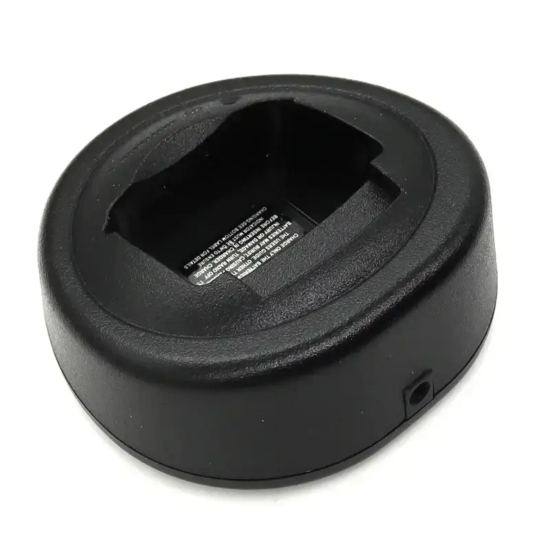 Black plastic circular motorola walkie talkie desktop charger with recessed slot for gp328 ht750 device insertion