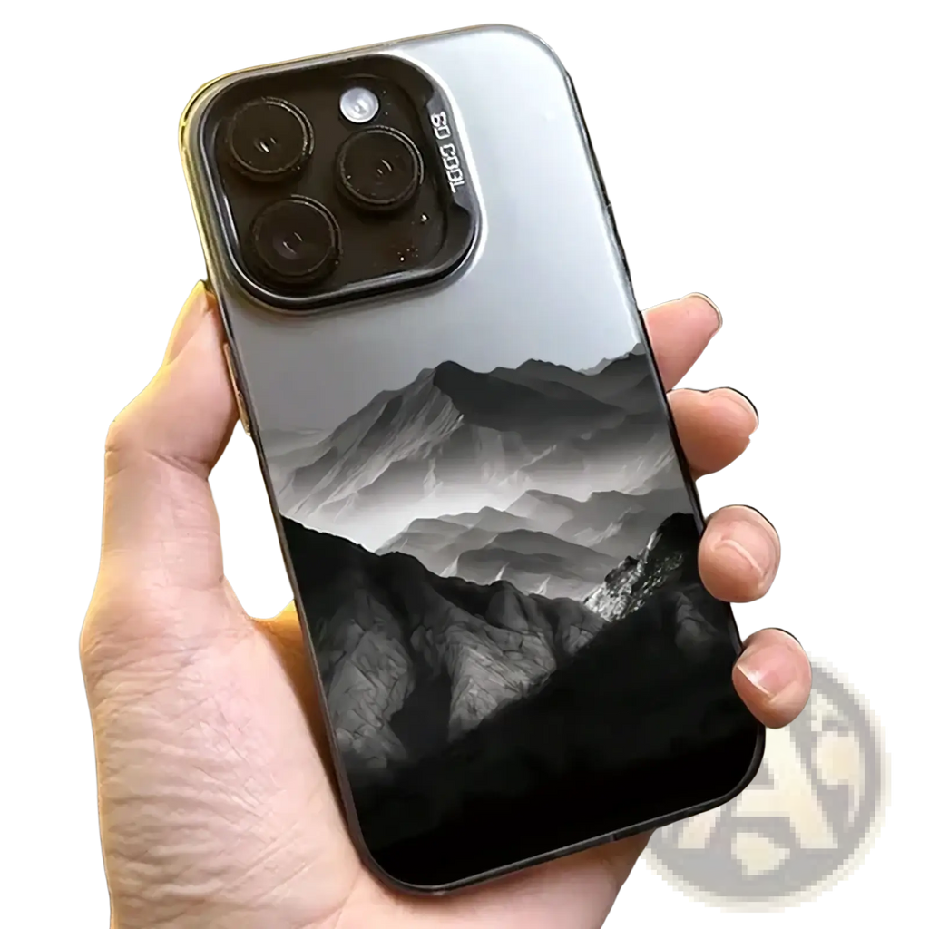 The back side of a sleek silver iPhone 13 Pro with a black and white mountain landscape on glossy protective cover