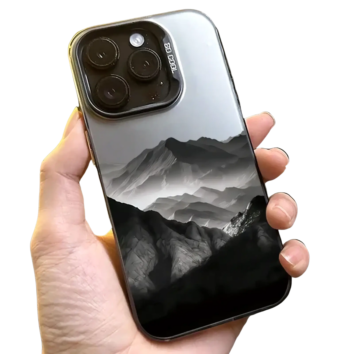 The back side of a sleek silver iPhone 13 Pro with a black and white mountain landscape on glossy protective cover