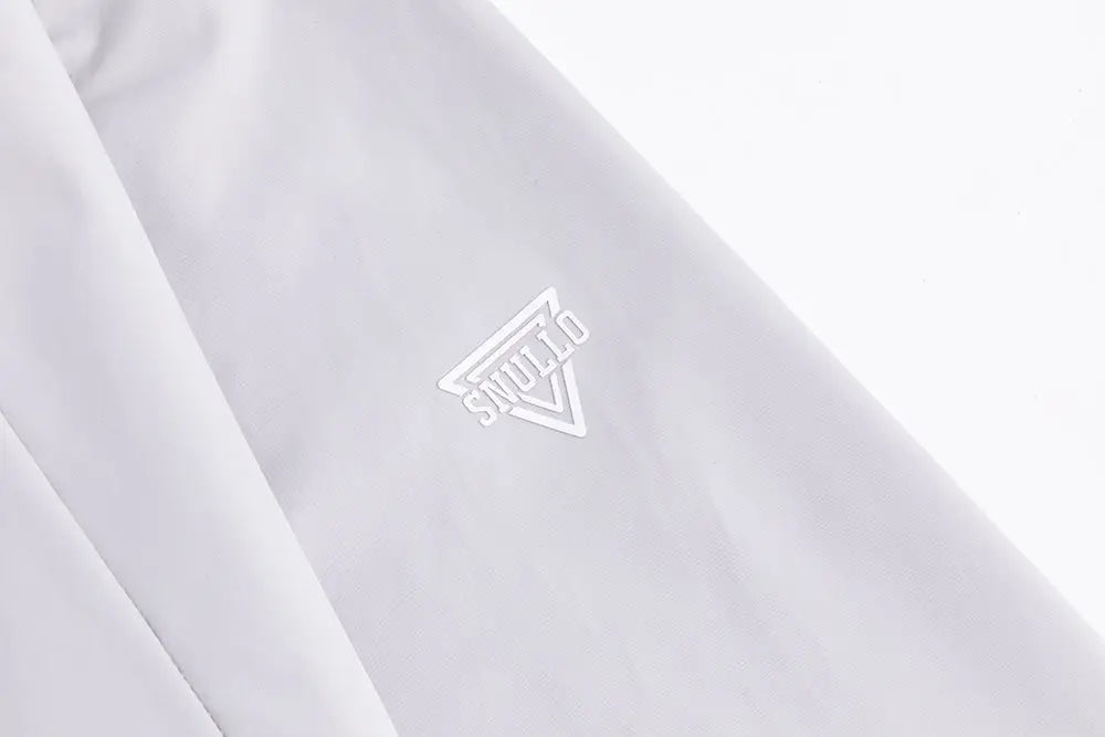 White studio triangle logo embroidered on smooth light fabric of professional men’s tactical mountaineering assault jacket