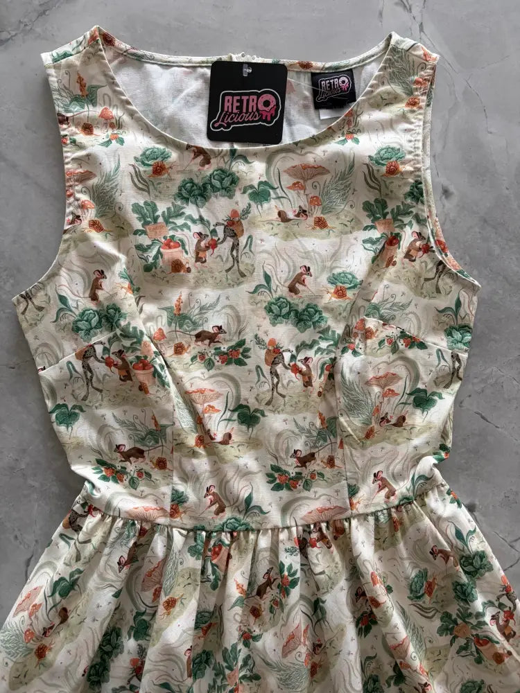 Cream-colored sleeveless vintage mouse print cotton a-line midi dress with pockets featuring monkeys and foliage design