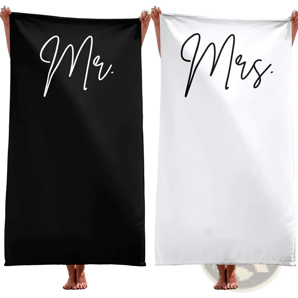 Black and white cotton beach towels with mr and mrs printed in elegant cursive for honeymoon wedding gift