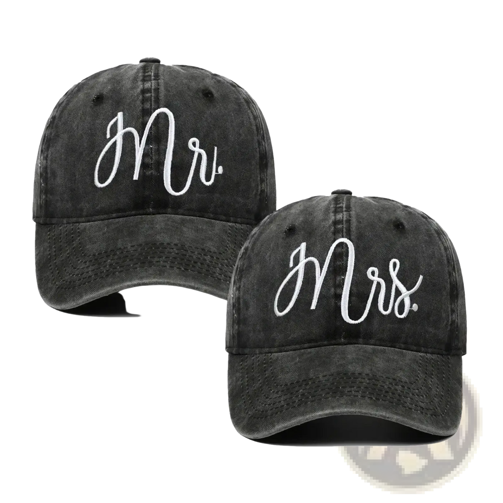 A pair of black distressed mr and mrs couple baseball caps with white cursive embroidered lettering