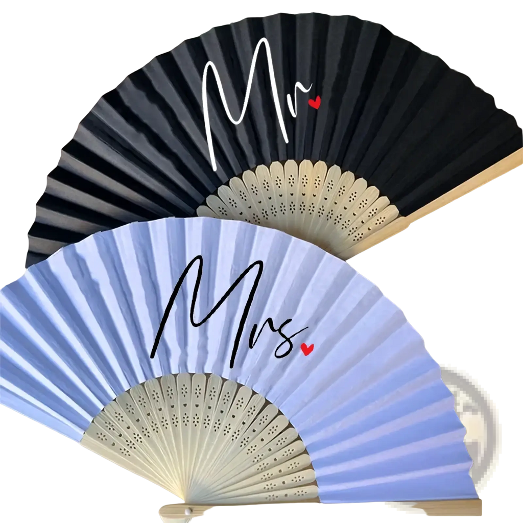 A pair of elegant foldable mr and mrs wedding hand fans with contrasting black and light blue colors and red heart accents