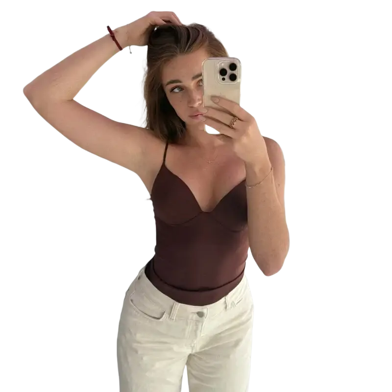 A woman holds a light-colored smartphone showing the back of a sexy backless satin corset crop top camisole