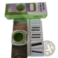 Multi-functional green and white stainless steel vegetable slicer shredder with interchangeable blades for versatile use