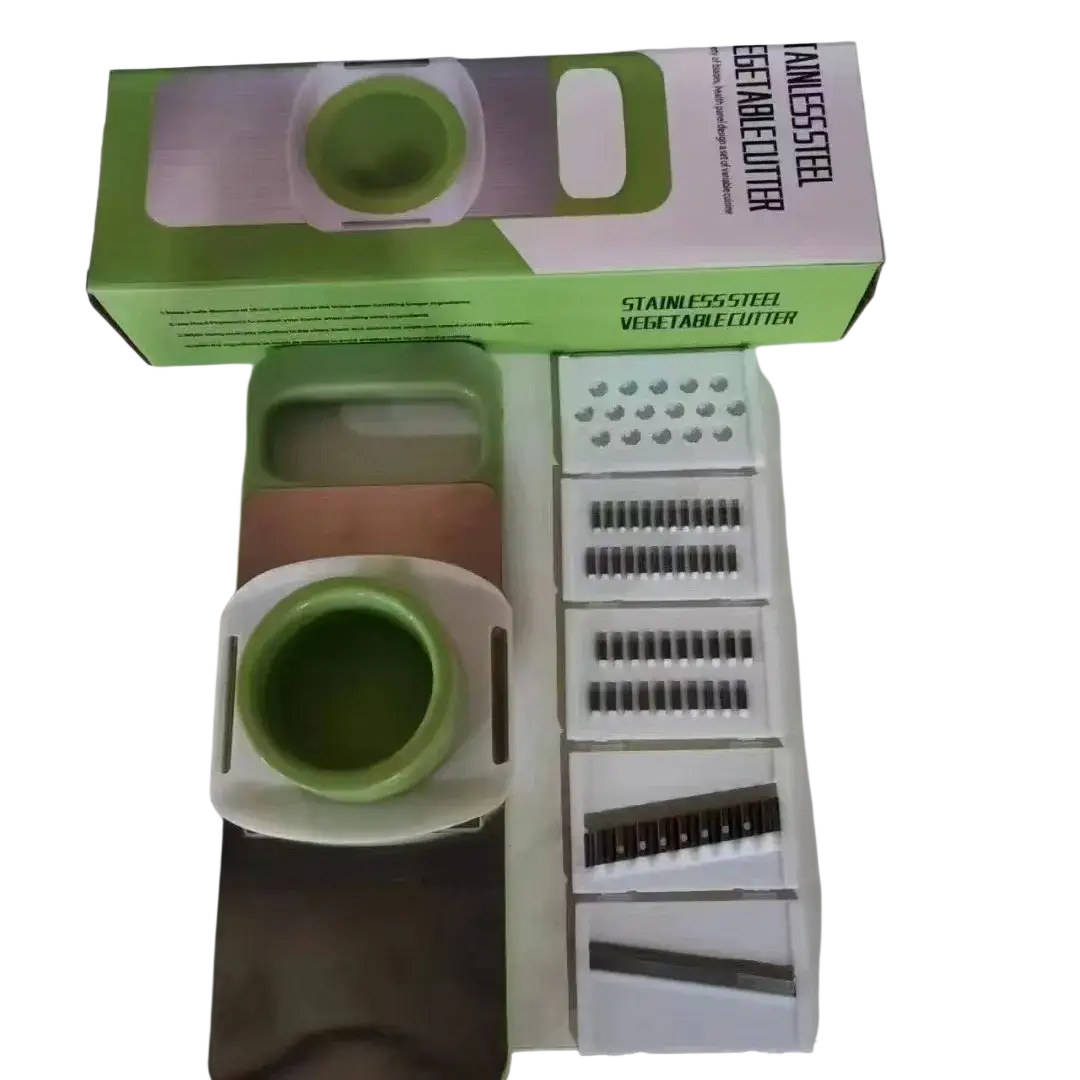 Multi-functional green and white stainless steel vegetable slicer shredder with interchangeable blades for versatile use