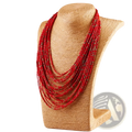 Multi-layer boho red beaded statement necklace with subtle gold accents displayed on a textured mannequin bust