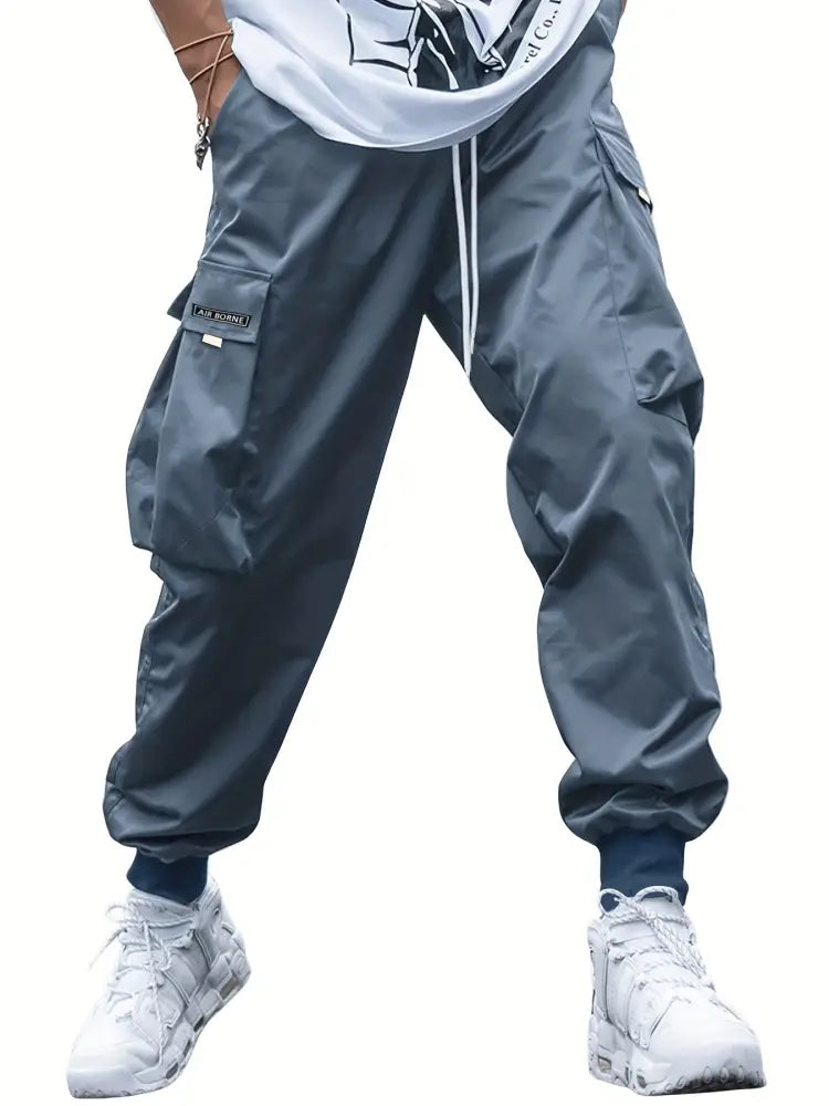 Men’s dark gray multi-pocket streetwear cargo joggers with drawstring waistband and functional cargo pockets