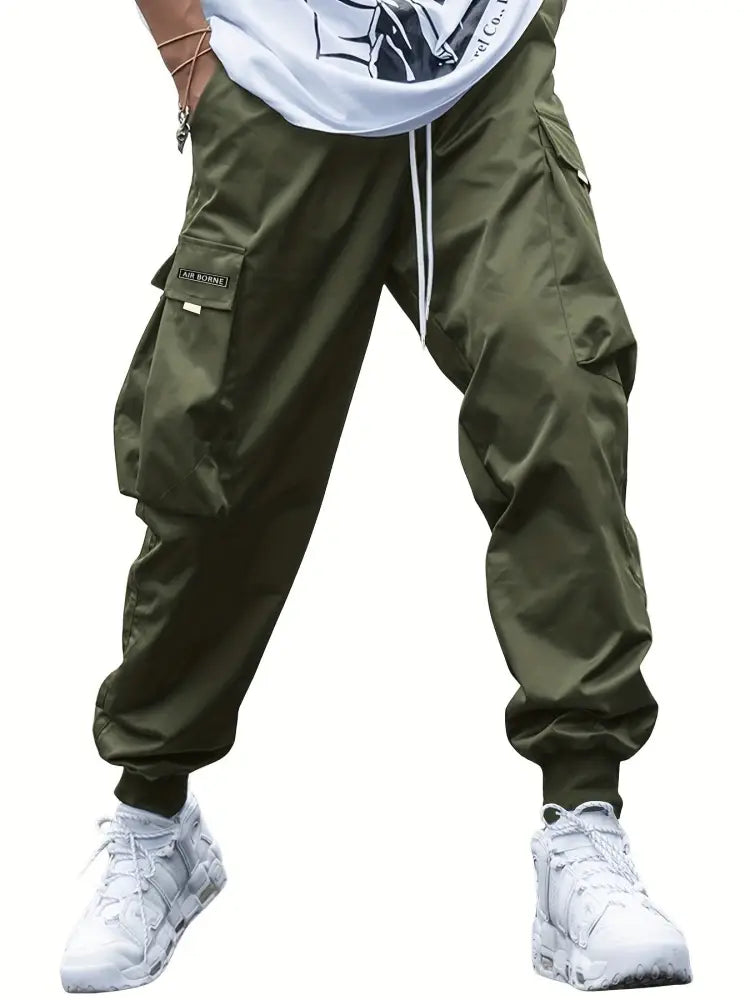 Men’s olive green multi-pocket streetwear cargo joggers with drawstring waistband and durable fabric for casual wear