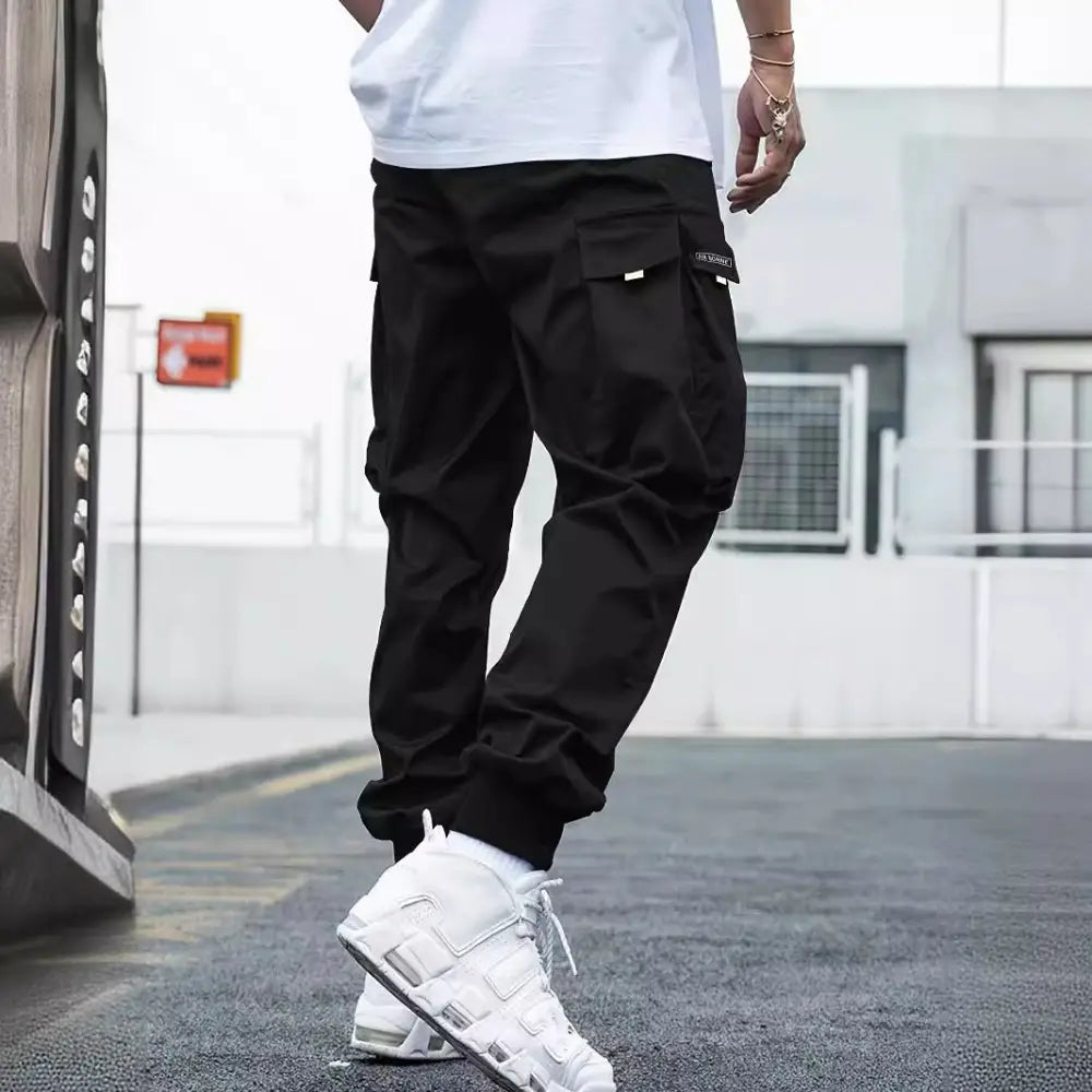 Men’s black cargo joggers with multiple pockets and a drawstring waistband for streetwear style and comfort