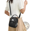 Black compact nylon crossbody bag with front flap, silver metal hardware, zippers, and earbud case attachment