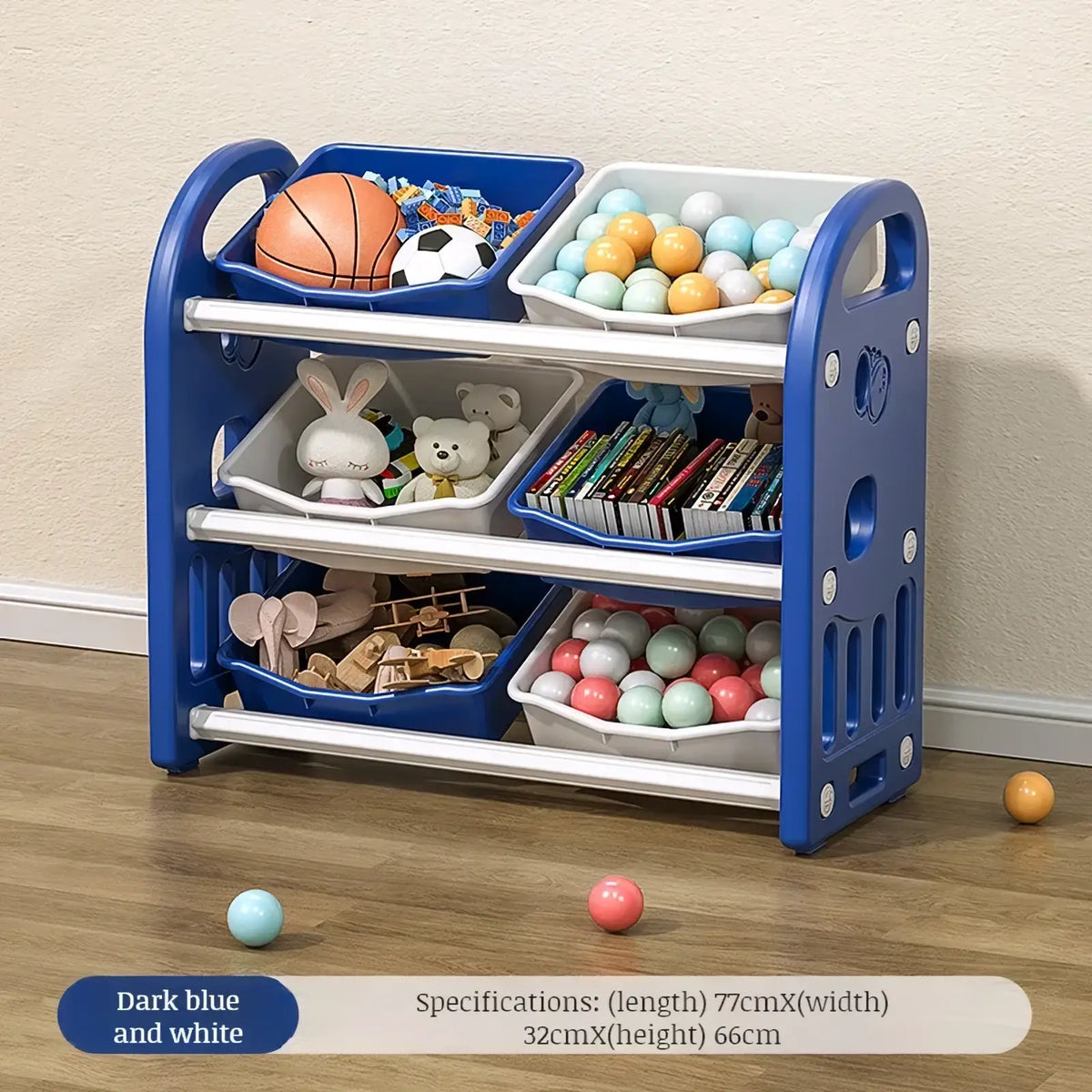 Blue and white plastic multi tier toy storage cabinet with three shelves holding balls books and stuffed animals