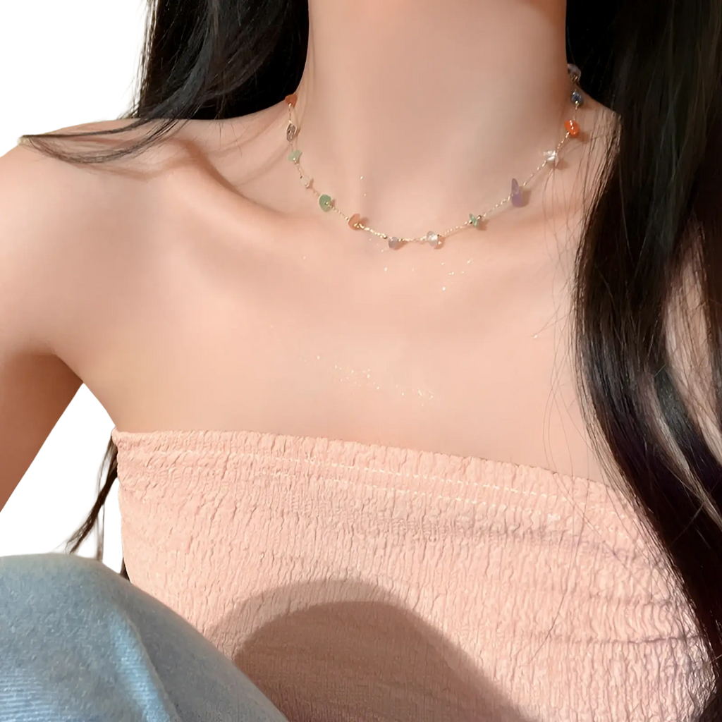 A multicolor gemstone choker necklace with butterfly pendants on a thin gold and silver alloy chain