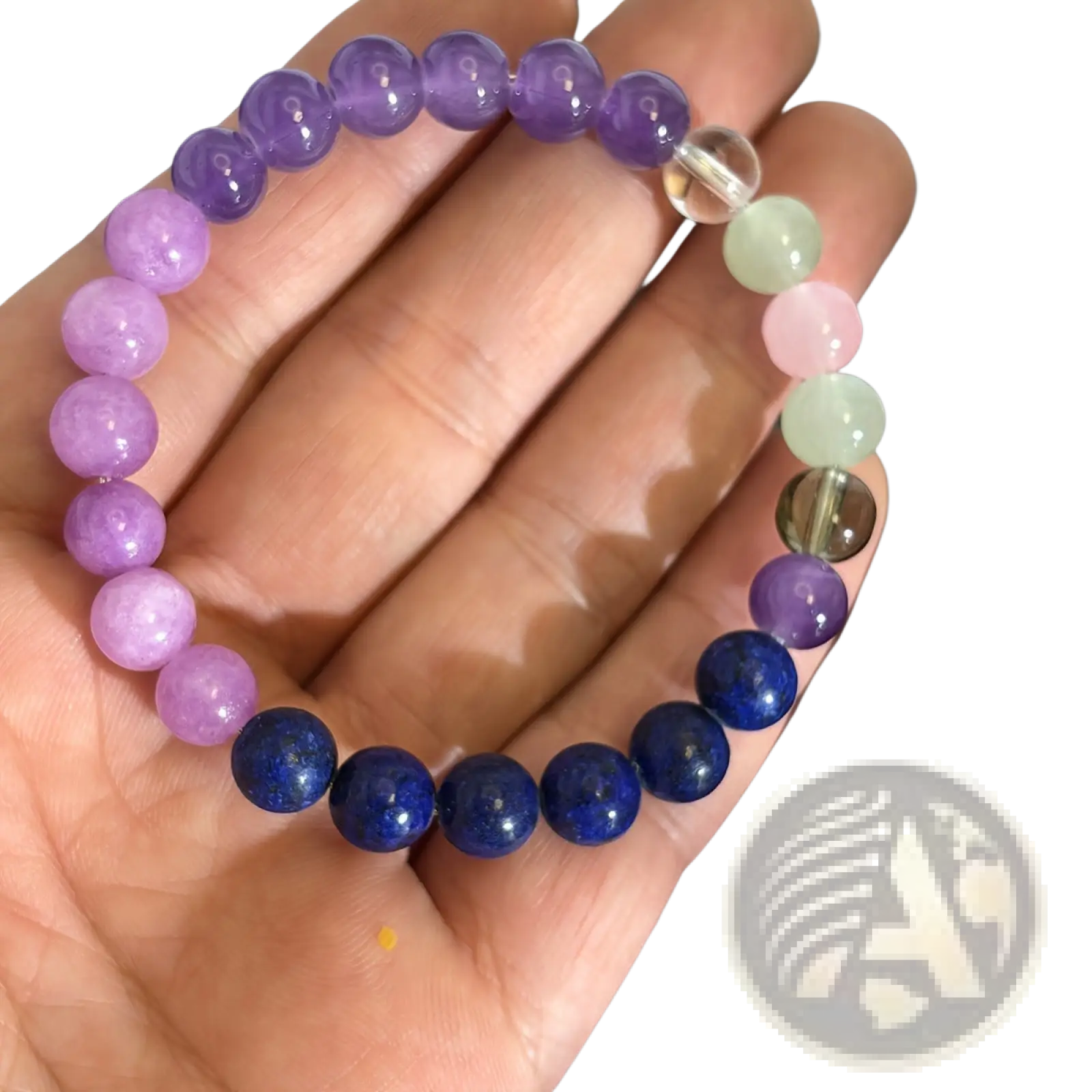 A hand holds a multicolor gradient fluorite beaded bracelet with smooth round stones and crystal accent