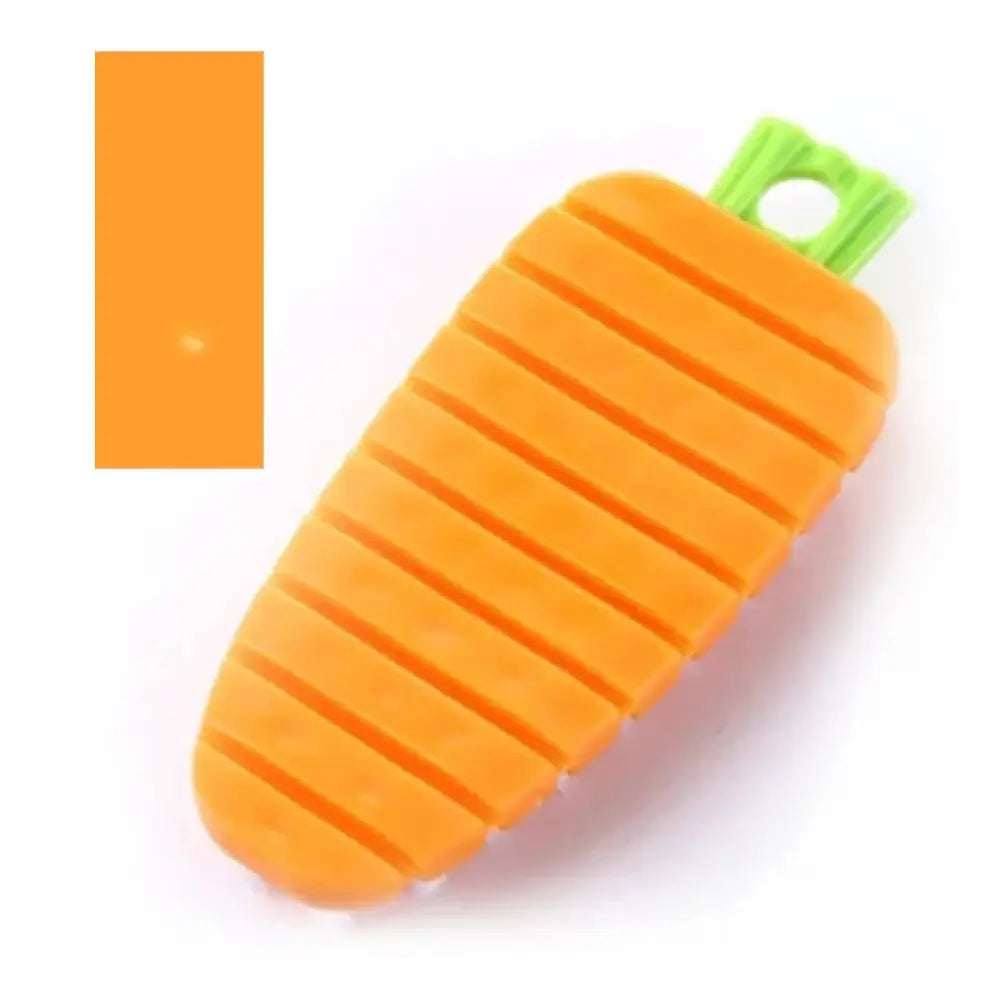 Flexible silicone vegetable and fruit cleaning brush shaped like an orange carrot with green stem and hanging hole