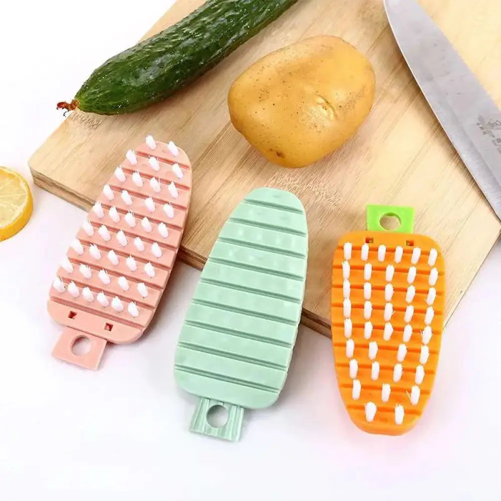 Three colorful vegetable-shaped flexible silicone body brushes with soft bristles and plastic handles for cleaning fruits and vegetables