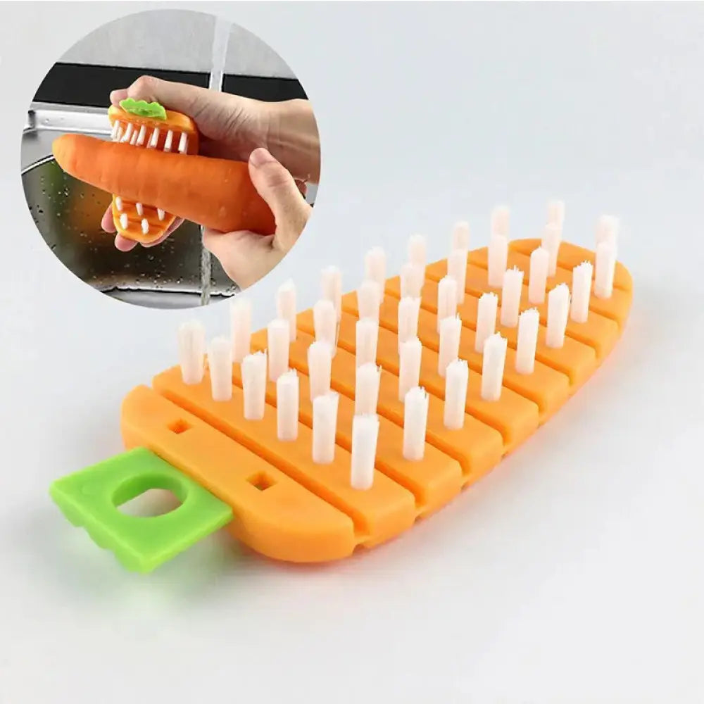 Flexible silicone vegetable and fruit cleaning brush shaped like an orange carrot with white bristles and a green handle